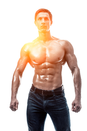 Muscular handsome young man with naked torso. Isolated on whiteの写真素材