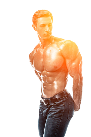 Muscular handsome young man with naked torso. Isolated on whiteの写真素材