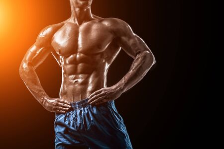 Muscular and fit young bodybuilder fitness male model posing oveの写真素材