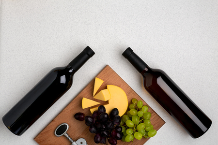 Bottles of red and white wine on white background from top viewの写真素材