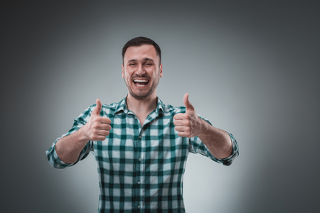 Portrait of man on gray background. Man showing different emotions.の写真素材