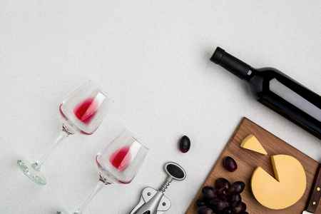 Wine, glasses and corkscrew over white background. Top viewの写真素材