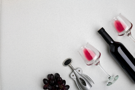Wine, glasses and corkscrew over white background. Top viewの写真素材