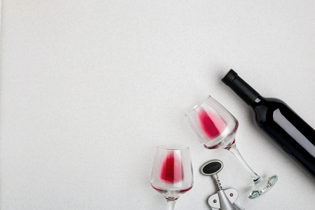 Wine, glasses and corkscrew over white background. Top viewの写真素材