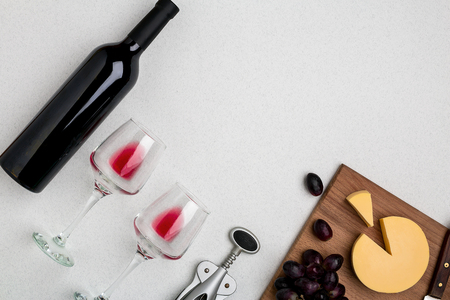 Wine, glasses and corkscrew over white background. Top viewの写真素材