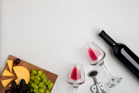 Wine, glasses and corkscrew over white background. Top viewの写真素材