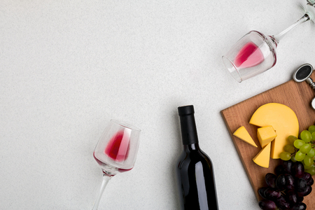 Two glasses of red wine, cheese and grapes. Top viewの写真素材