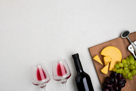 Two glasses of red wine, cheese and grapes. Top viewの写真素材