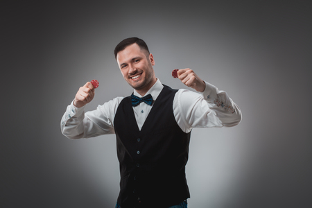 A man holding up red poker chips. Pokerの写真素材
