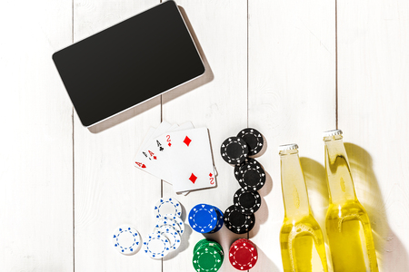 Poker. Set to playing poker with cards and chips on white wooden table, top view. Copy spaceの写真素材