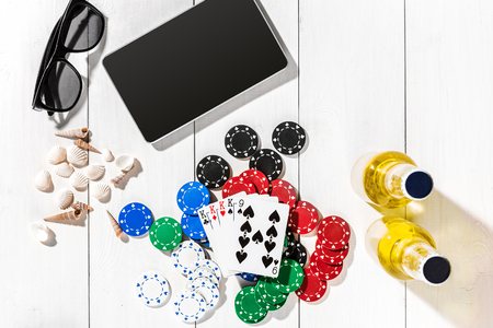 Poker. Set to playing poker with cards and chips on white wooden table, top view. Copy spaceの写真素材