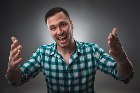 Portrait of excited man looking at the camera and points at you with a finger.の写真素材