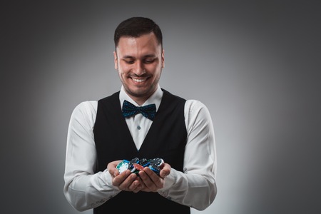 A man holding up poker chips. Pokerの写真素材