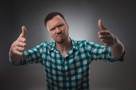 Portrait of excited man looking at the camera and points at you with a finger.の写真素材