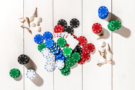 Poker. Set to playing poker with cards and chips on white wooden table, top viewの写真素材