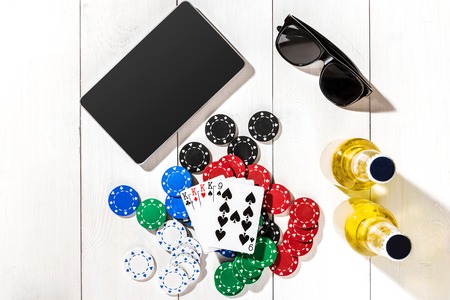 Poker. Set to playing poker with cards and chips on white wooden table, top viewの写真素材