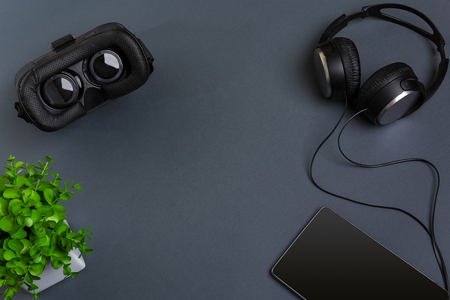 Virtual reality glasses and tablet with headphones on a gray background. Top viewの写真素材