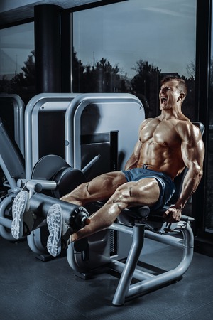 Leg Exercises - Man Doing Leg With Machine In Gymの写真素材