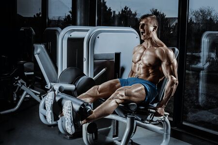 Leg Exercises - Man Doing Leg With Machine In Gymの写真素材