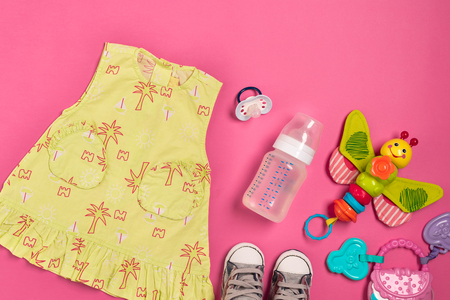 Baby clothes and accessories on pink background. Top viewの写真素材