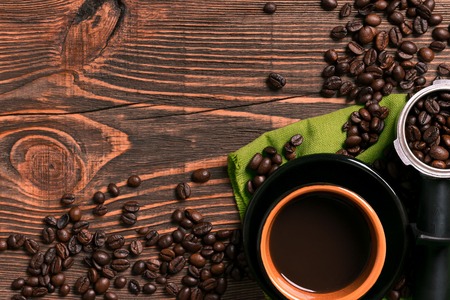 Coffee cup and beans frame on wooden tableの写真素材