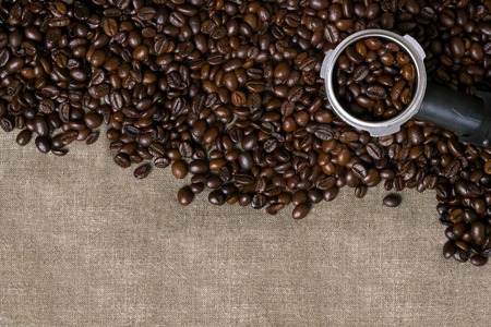 Coffee beans on burlap background.の写真素材
