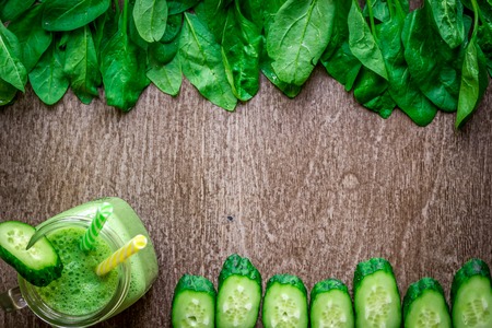 Glass of spinach juice on wooden backgroundの写真素材