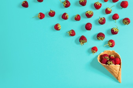 Strawberry in a waffle horn on a blue backgroundの写真素材