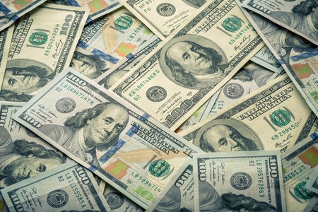 Lot of one hundred dollar bills close-up background