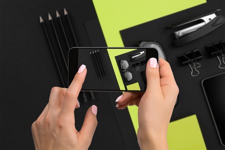 Shooting black stationery on phones camera. Stationery on black-green background.の写真素材