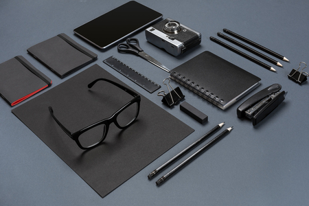 Black office stuff collection flat lay. Top view on set of stationery with smartphoneの写真素材