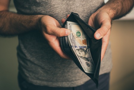 Man looks in the wallet. Cash. Wealthy man counting his money. Close up.