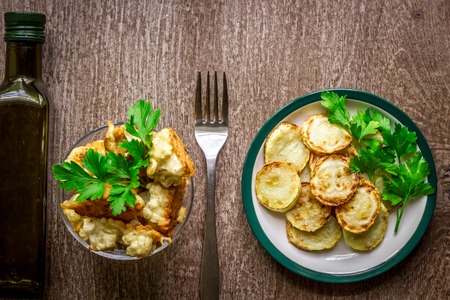 Cauliflower and zucchini baked in batter on a wooden background.の写真素材