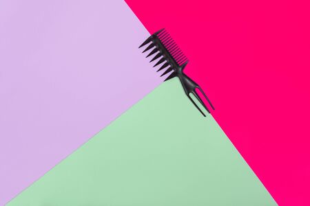 Comb on the color pink,lilac, green paper background. Top viewの写真素材