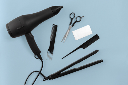 Hairdresser set with various accessories on blue backgroundの写真素材