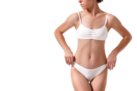 Slim tanned womans body. Isolated over white background.の写真素材