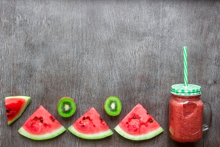 Smoothie of watermelon and kiwi on wooden backgroundの写真素材