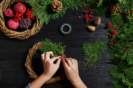 Manufacturer of Christmas decor with their own hands. Christmas wreath for the holiday. The new year celebration. Top viewの写真素材