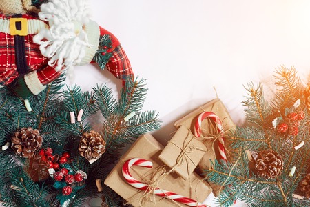 Christmas or New Year background: fur-tree, branches, gifts, decoration on a white background. Sun flareの写真素材