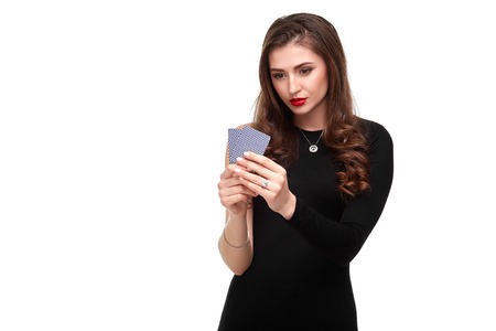 Sexy curly hair brunette posing with two aces cards in her hands, poker concept isolation on white backgroundの写真素材