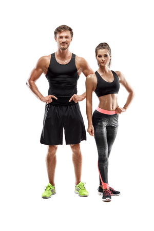 Sport, fitness, workout concept. Fit couple, strong muscular man and slim woman posing on a white backgroundの写真素材