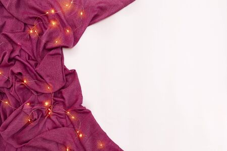 Scarf and Christmas lights on white background. Top viewの写真素材
