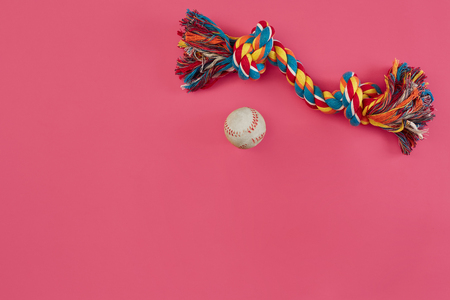 Toys -multi coloured rope and ball. Accessories for play on pink background top viewの写真素材