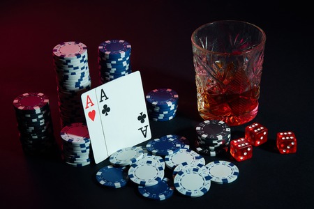 Poker cards with cubes are beautifully placed on the table, against the background of poker chips