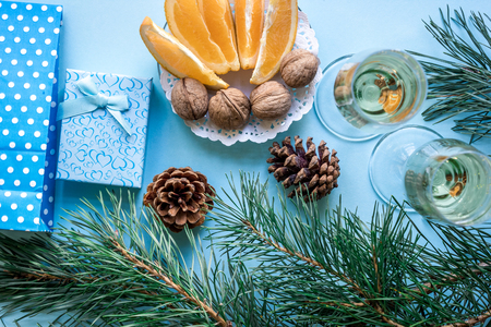 New Years holiday with spruce branches, Christmas presents and with a pair of wine glasses of champagne. Flat lay, top view, copy spaceの写真素材