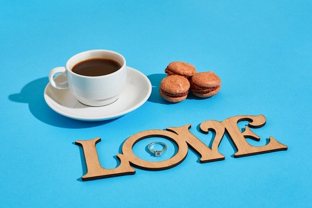 Tasty sweet macarons and coffee cup. Macaroons on blue backgrounの写真素材