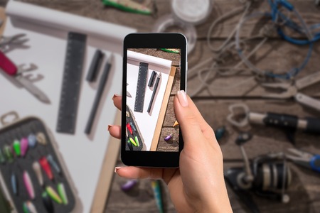 Fishing equipment with a cellphone. The photo is taken with telephoneの写真素材