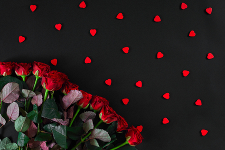 Bouquet of red roses on a black background. Top view. Flat lay. Copy space. Still life. Valentines day greeting card.の写真素材