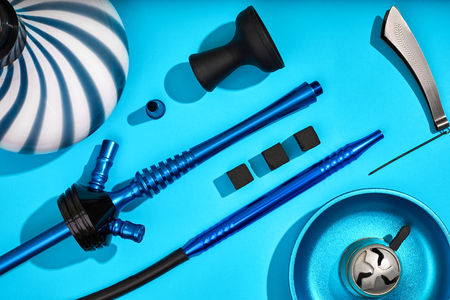 Parts of blue decorated hookah or shisha on light blue backgrounの写真素材