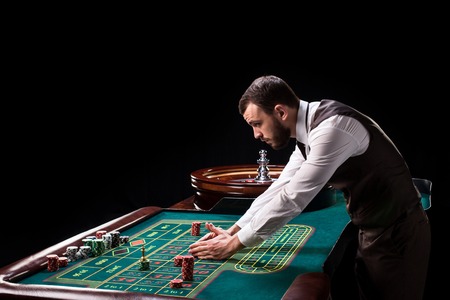 Croupier behind gambling table in a casino.の写真素材